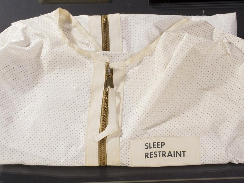 A white sack with a zipper and a label that read "Sleep Restraint"