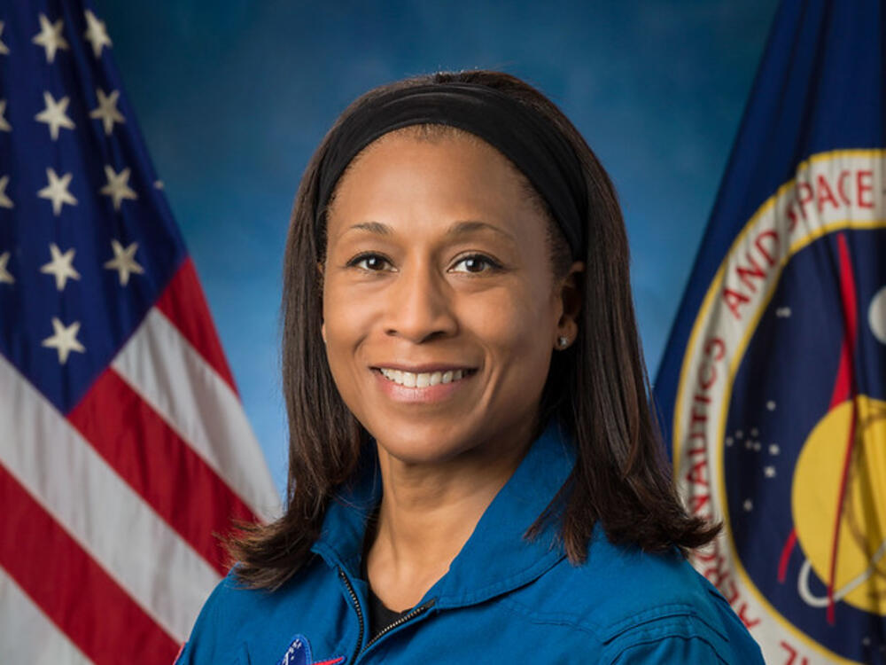 Official NASA portrait of Jeanette Epps wearing a blue astronaut flight suit.