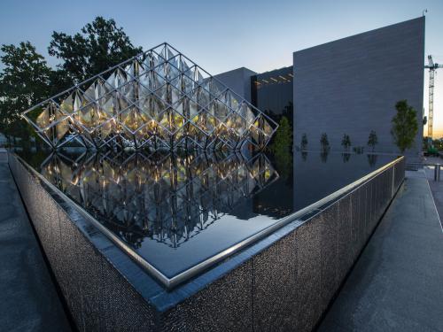 A statue in a water feature stands in front of the National Air and Space Museum.